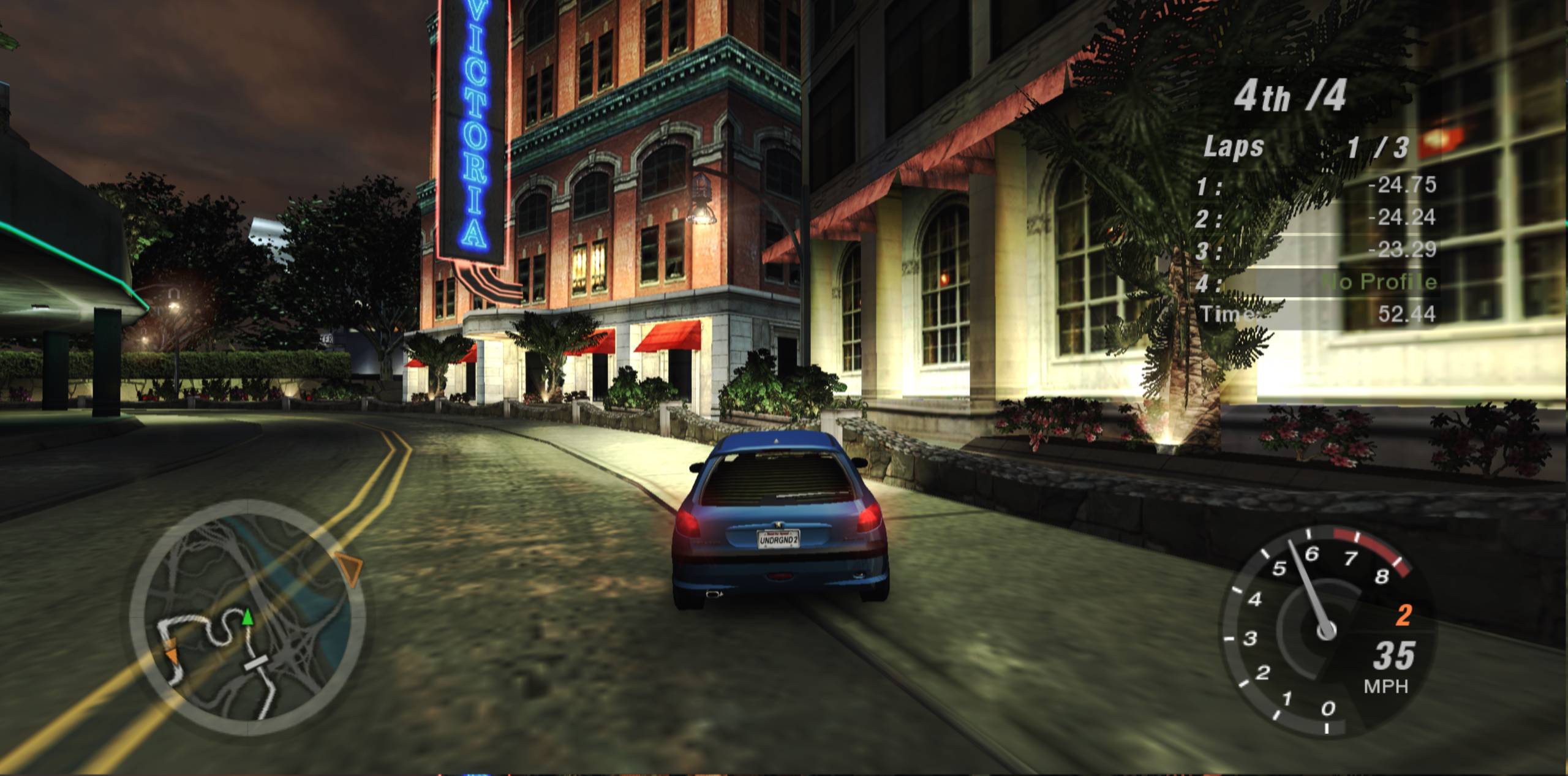 A Peugeot 206 racing through Bayview at night in Need for Speed Underground 2